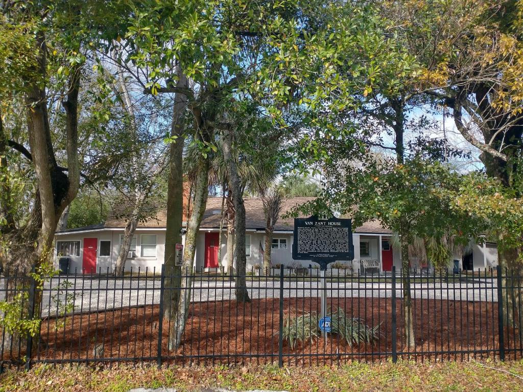 a fence with a sign in front of a house at The Van Zant House in Jacksonville