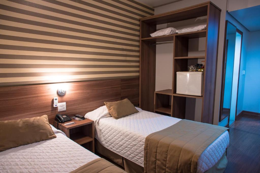 Postel nebo postele na pokoji v ubytování Hotel Continental Business - 200 metros do Complexo Hospitalar Santa Casa