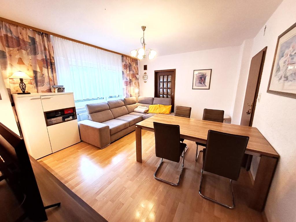 a living room with a table and a couch at Neue moderne ganze 90 qm² Ferienwohnung Berta in Brilon Madfeld in Brilon