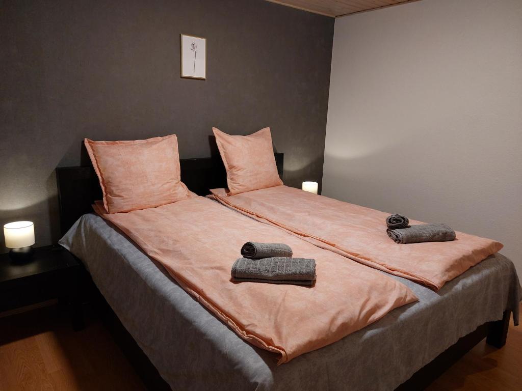 a large bed with two pillows on top of it at Venos rooms in Hirtshals