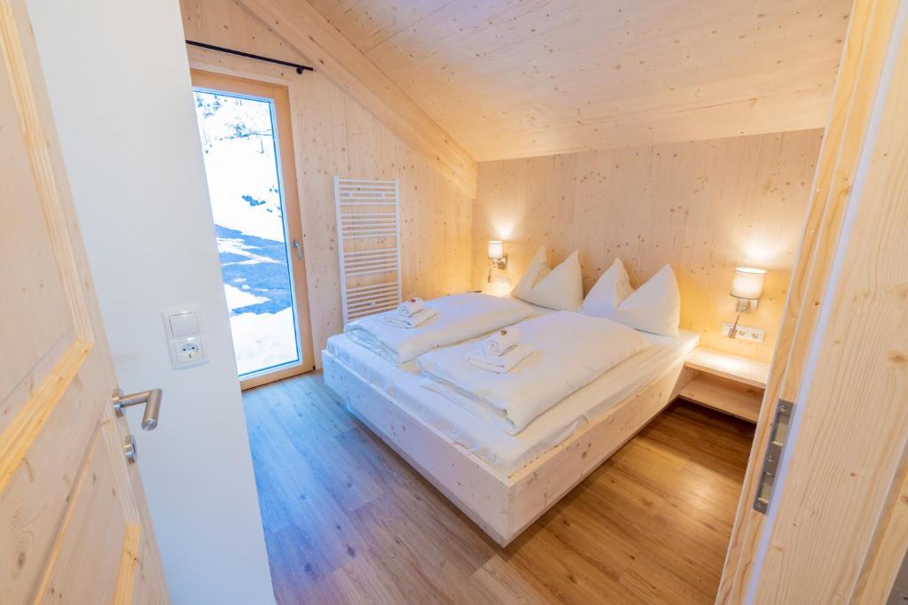 a large white bed in a room with a window at Chalet Bavaria in Sankt Lorenzen ob Murau