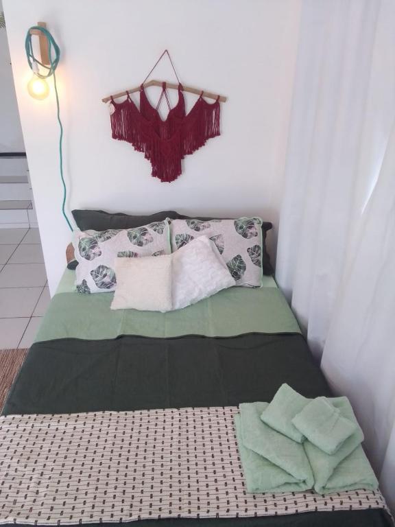 a small bedroom with a bed with towels on it at Jardim Urbano Cambará do Sul in Cambara do Sul