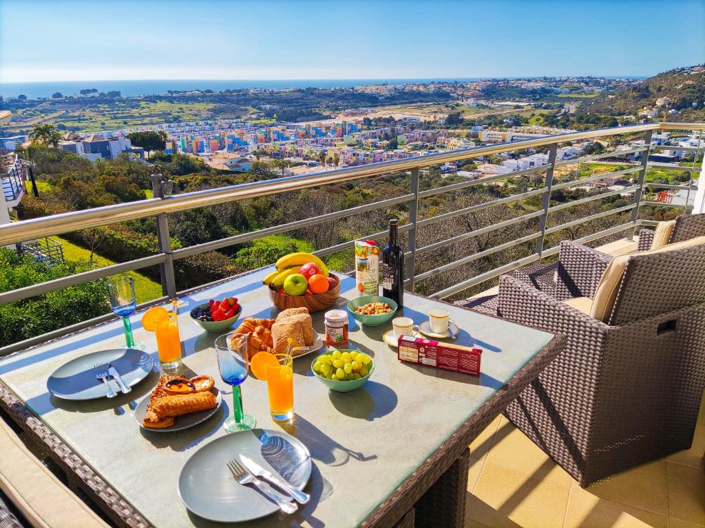 a table with food on top of a balcony at AlbufeiraOrada by Be Cherish in Albufeira
