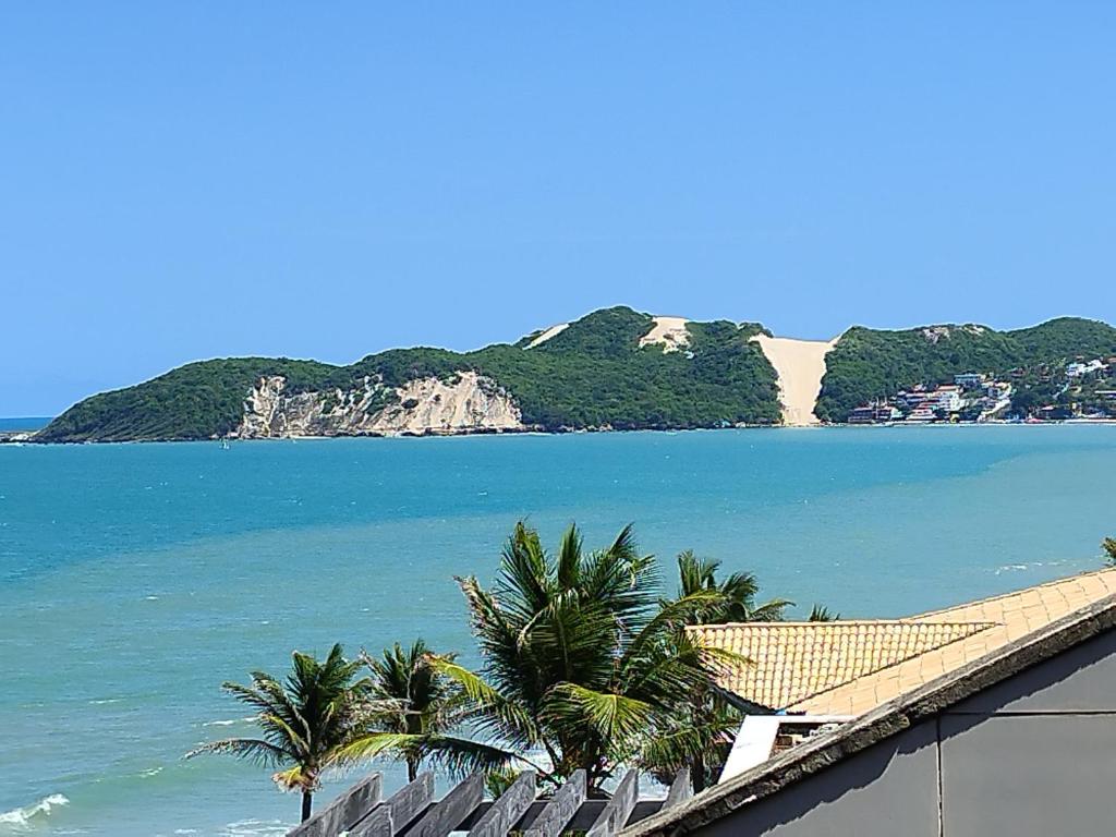 a view of a beach with palm trees and the ocean at Atlântico Flat -207- Vista ao Mar e Pé na Areia in Natal