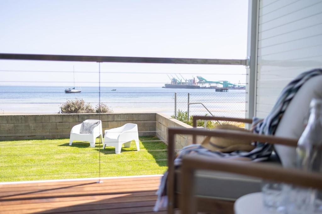 a patio with a view of the beach and the ocean at Port Lincoln Beachfront Apartments in Port Lincoln