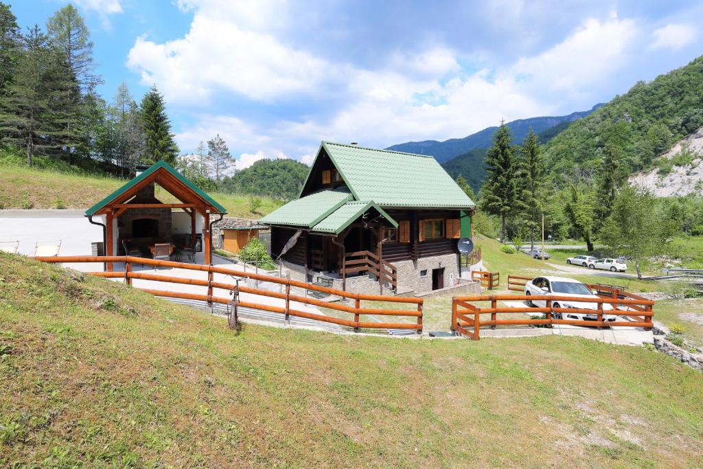 une grande maison avec une clôture devant elle dans l'établissement Holiday house with a parking space Kuzelj, Gorski kotar - 20489, à Delnice