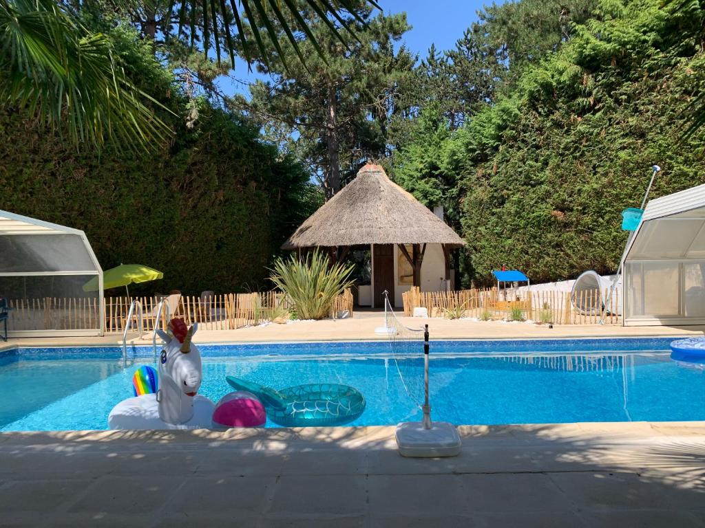 a swimming pool with a statue of a dog next to it at Disney cottage in Coupvray