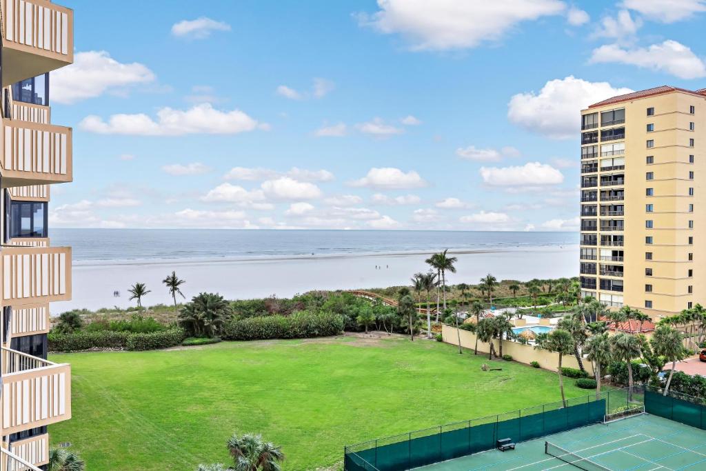 a view of the beach from the balcony of a building at Beachfront condo with pool, tennis and fitness center in Marco Island