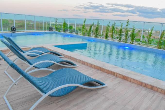 a group of chairs sitting next to a swimming pool at Seller residence in Sobral
