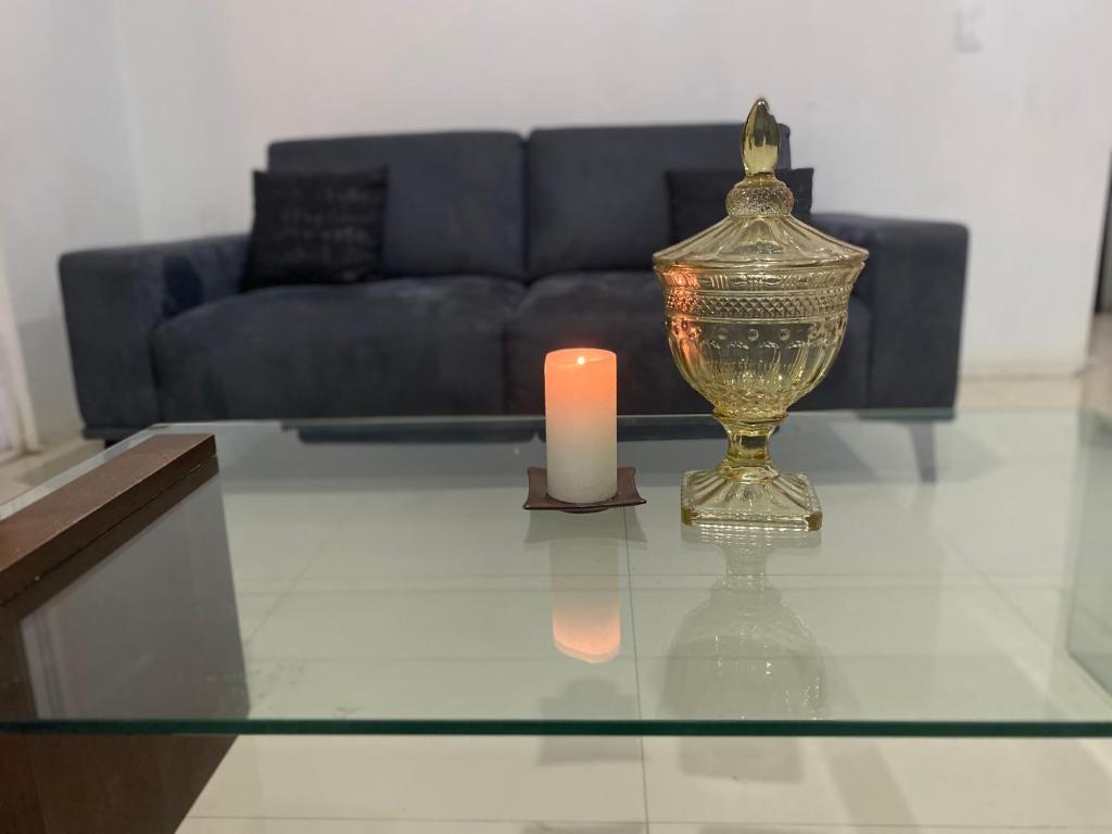 a candle and a glass table in a living room at Suite’s Pool in Yelateni