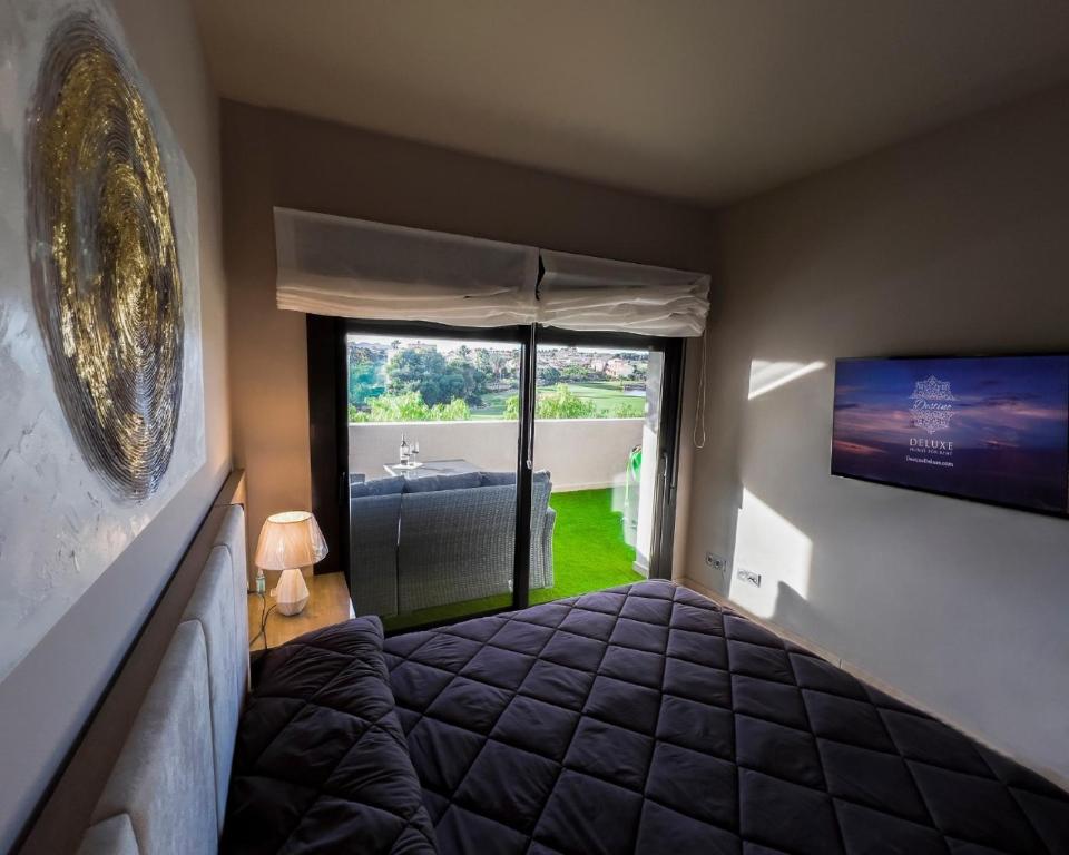a bedroom with a bed and a large window at Penthouse Valle del Este Deluxe in Vera