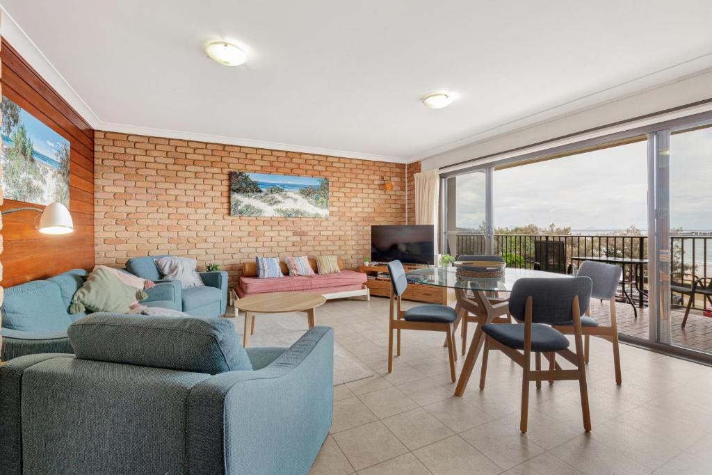 a living room with a couch and a table at Illawong Apartments in Mooloolaba