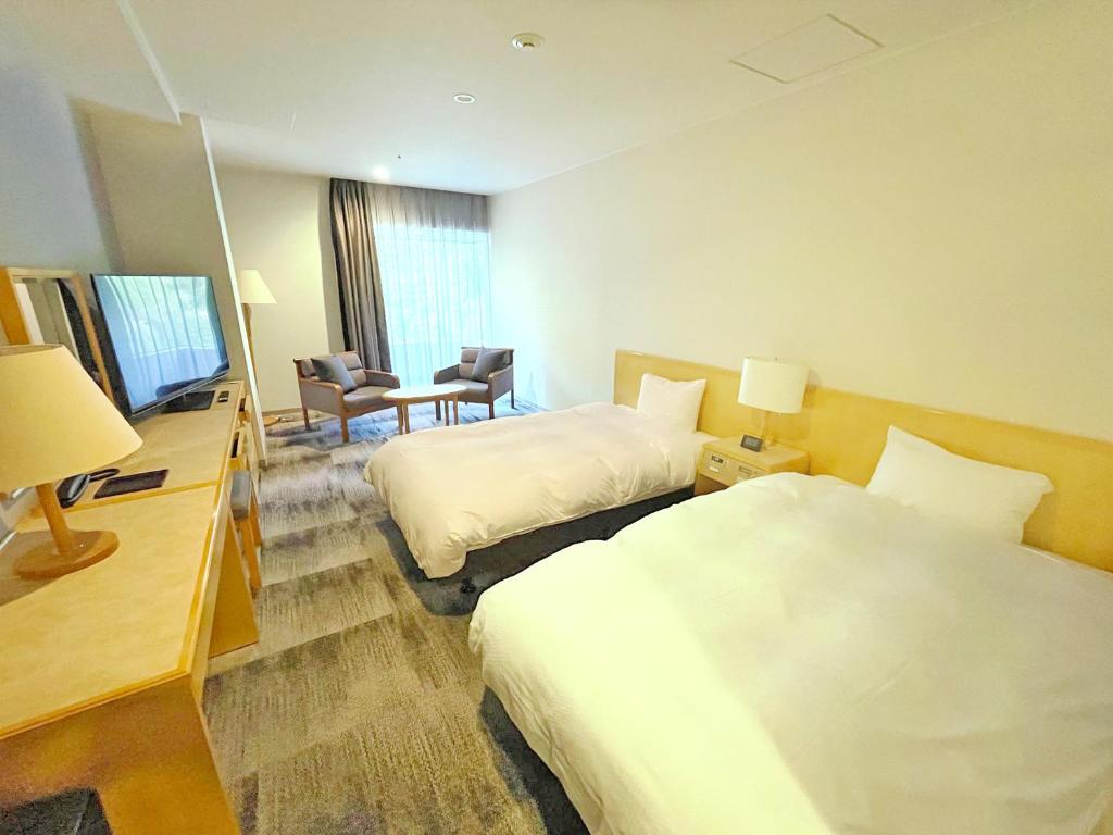 Postel nebo postele na pokoji v ubytování Grandvrio Hotel Unazukionsen