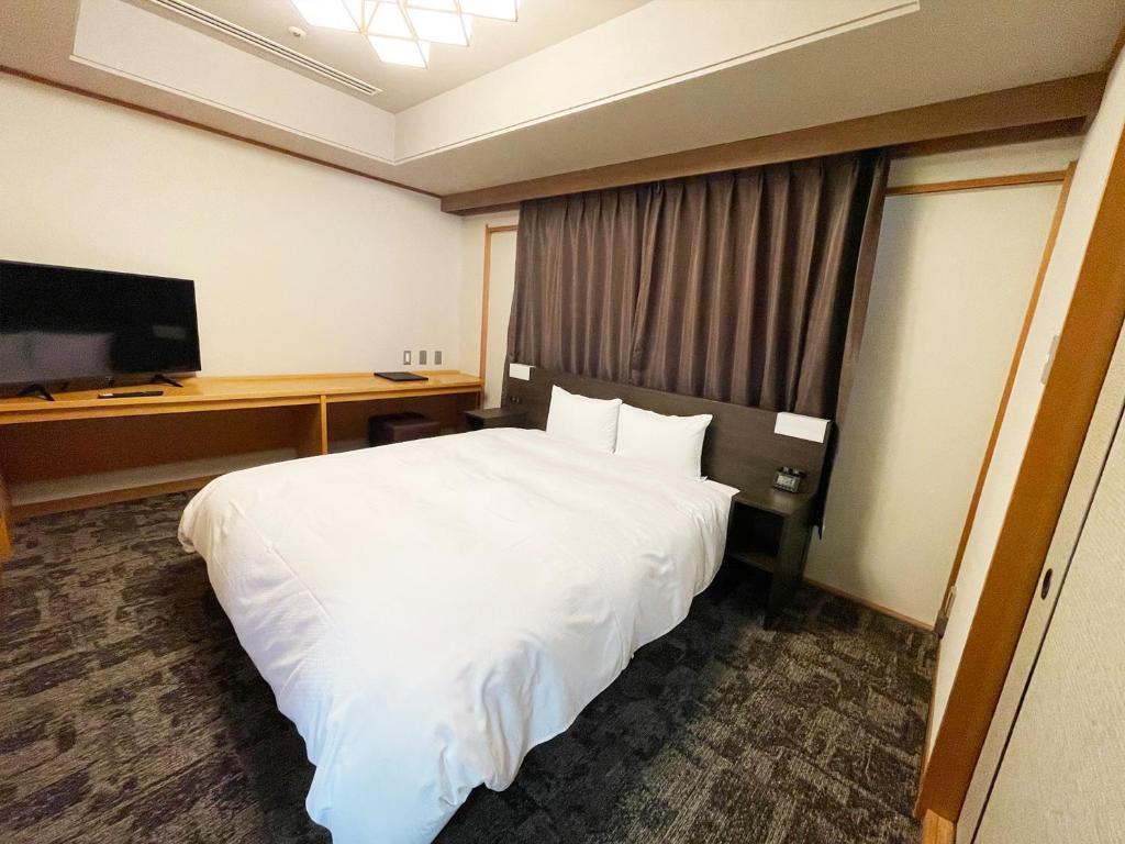 Postel nebo postele na pokoji v ubytování Grandvrio Hotel Unazukionsen