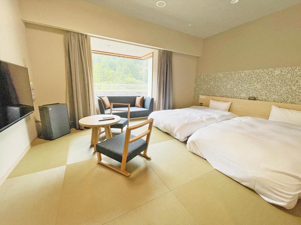 Postel nebo postele na pokoji v ubytování Grandvrio Hotel Unazukionsen