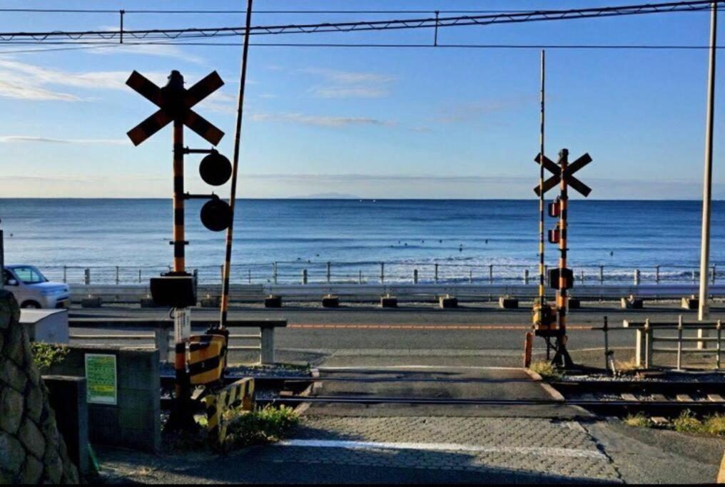 dois cruzamentos no lado de uma estrada perto da praia em Seaside House Enoshima 江ノ島, Free Parking 漫居湘南海岸, 尋訪灌籃高手 em Koshigoe