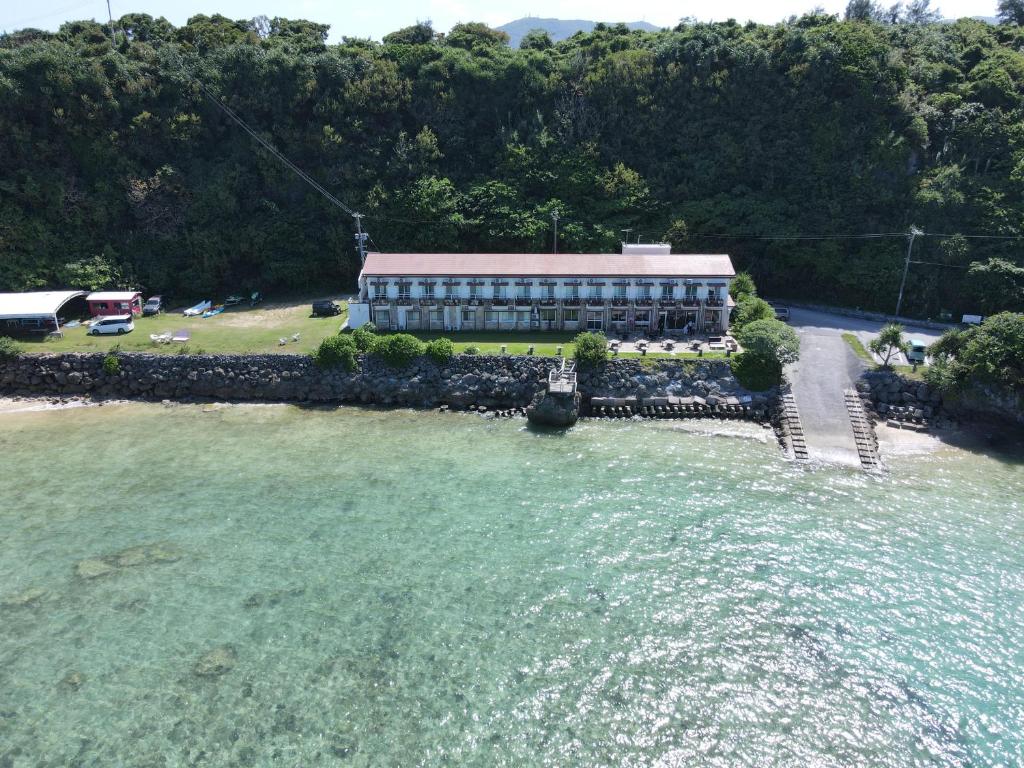 an aerial view of a building in the water at Hotel Oceans Nakijin in Nakijin