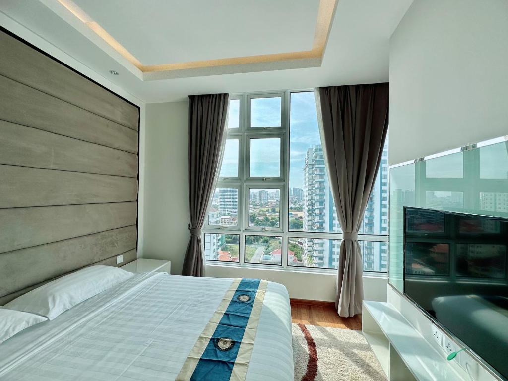 a bedroom with a bed and a large window at Infinity 28 Condominium in Phnom Penh