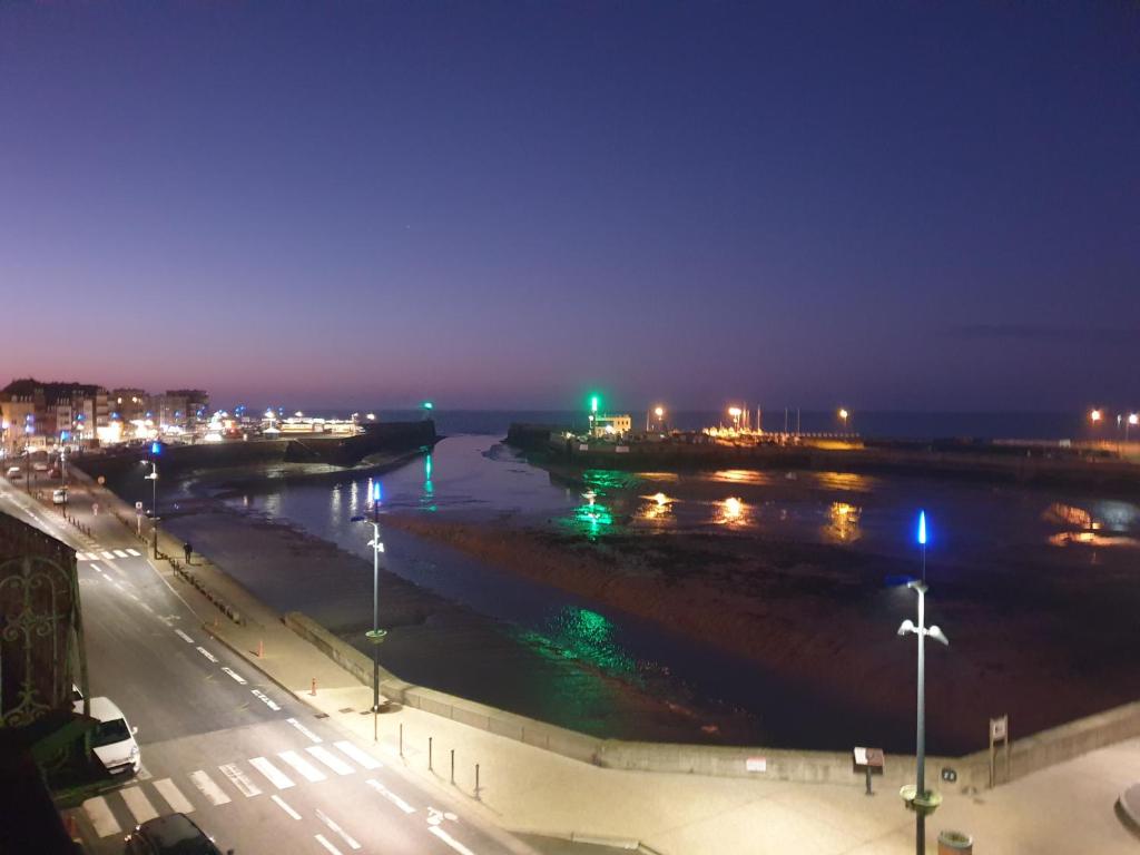vista sul fiume di notte con luci di O'3 PORTS a Le Tréport