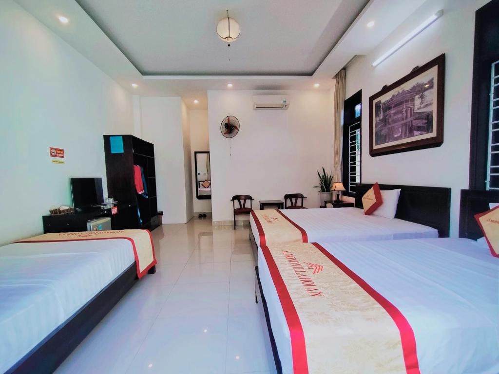 Postel nebo postele na pokoji v ubytování Almond Villa Hoi An