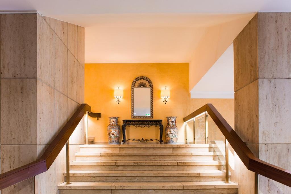 una escalera en una casa con paredes amarillas en Hotel Krefelder Hof, en Krefeld