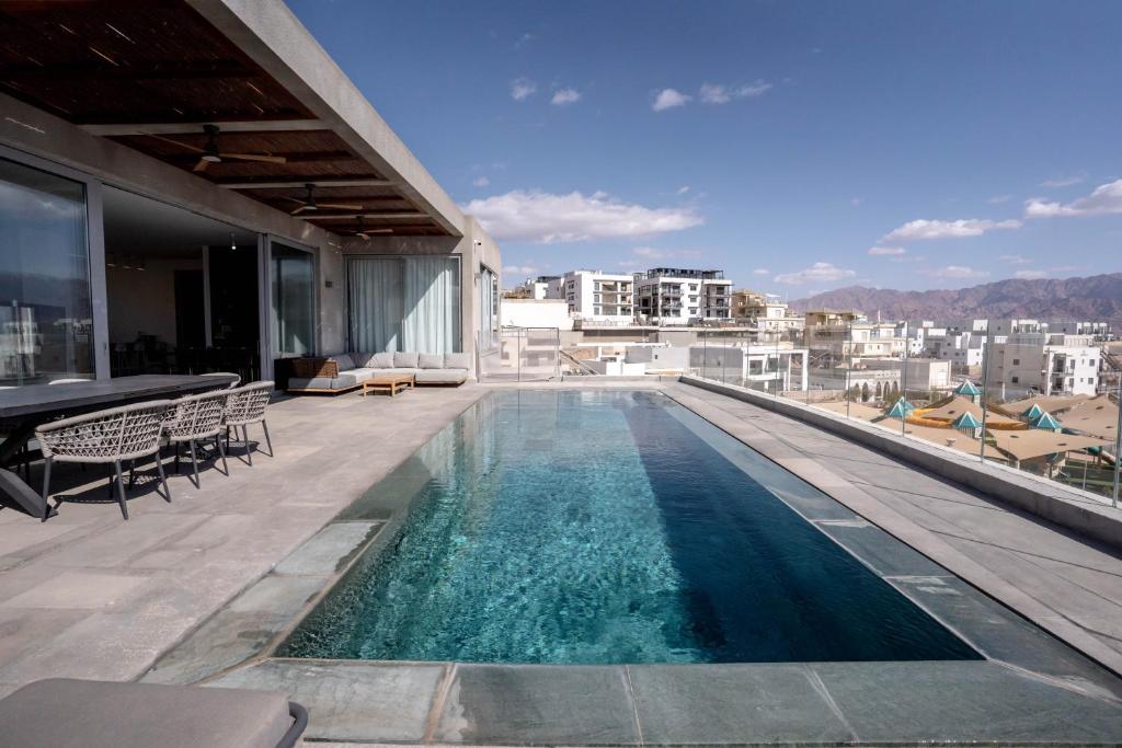 a swimming pool on the roof of a building at YalaRent Red Sea glory villa-private pool & jacuzzi in Eilat