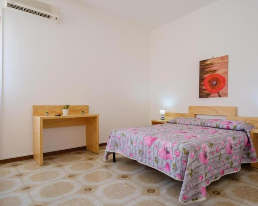 A bed or beds in a room at Casa Blasco Porto Cesareo