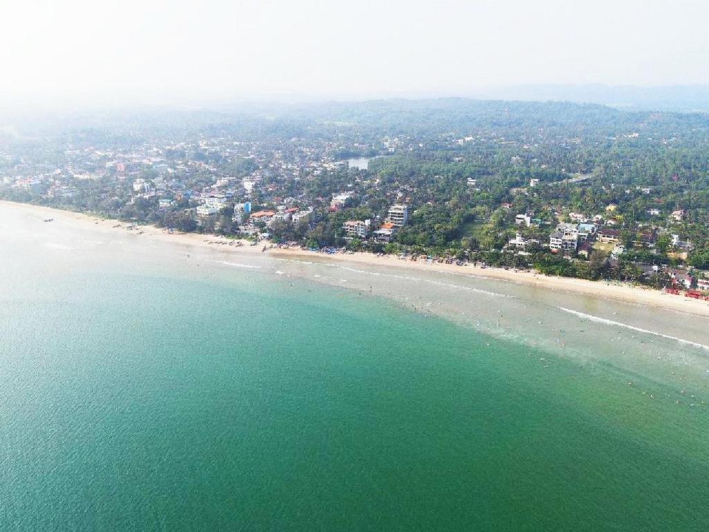 an aerial view of a beach and the ocean at Dazzle Bay by Twenty Two in Weligama