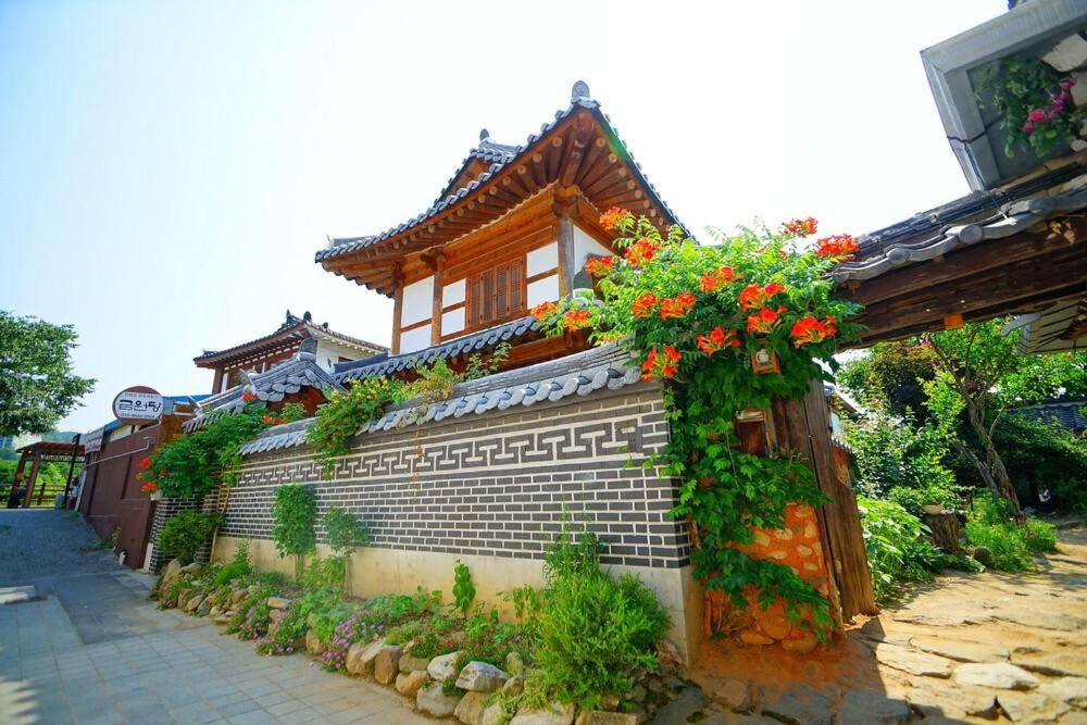 a building with flowers on the side of it at Kumwondang Jeonju Hanokstay in Jeonju