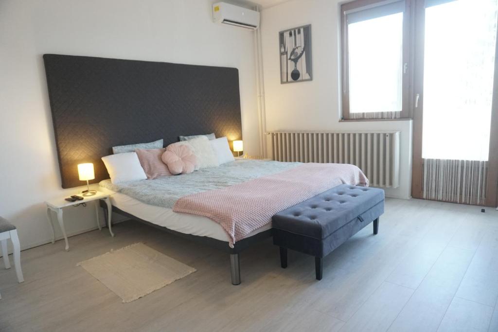 a bedroom with a large bed with pink pillows at Villa Grande Hévíz in Hévíz