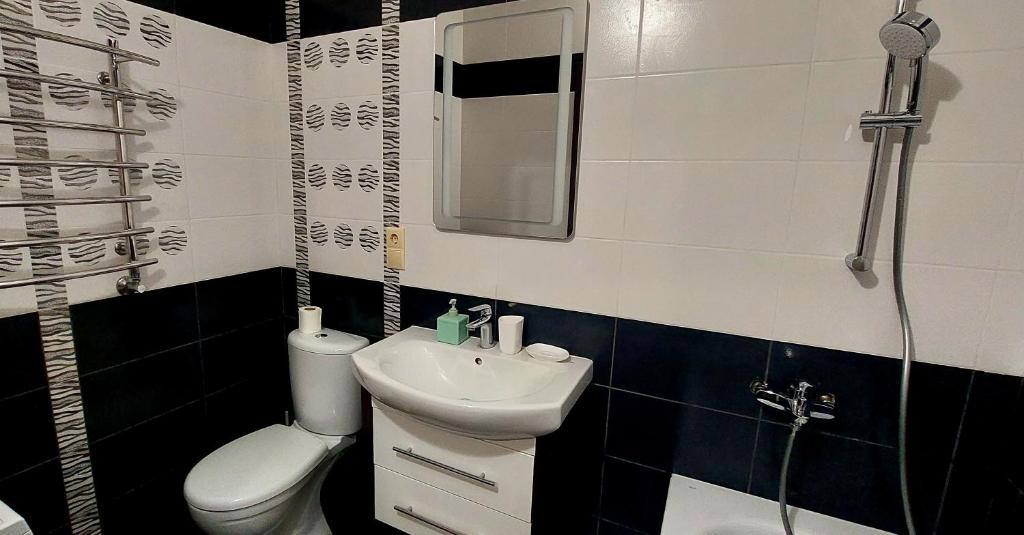 a bathroom with a sink and a toilet and a shower at Апартаменти Буча ЖК Центральний in Bucha