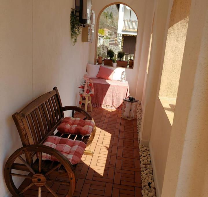 a porch with a bench and a bed in a room at Parányi Porta Bakonybél in Bakonybél
