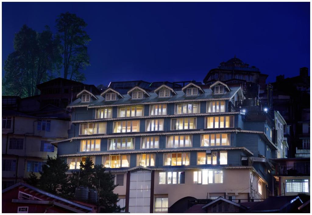 a large building with lit windows at night at Yashshree Mall Road Darjeeling in Darjeeling