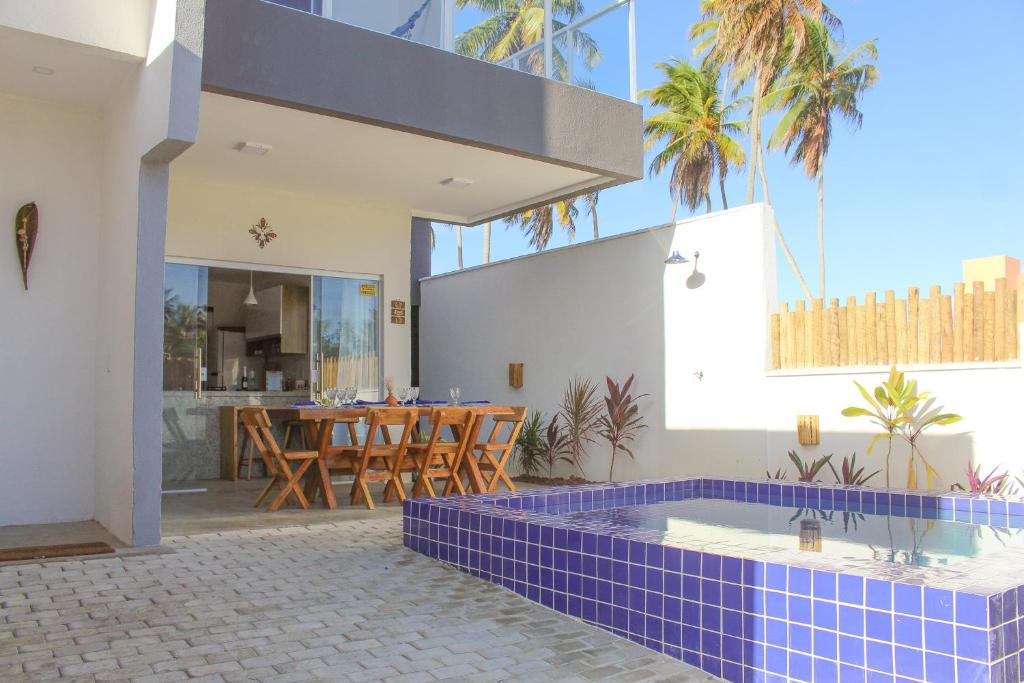 a house with a hot tub in a courtyard at Casa Mar do Patacho in Pôrto de Pedras