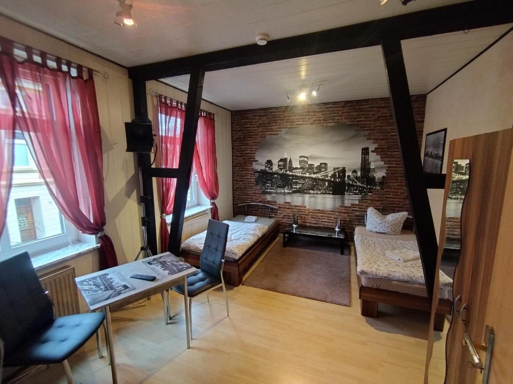 a living room with a bed and a brick wall at Boardinghouse Castell in Bonn