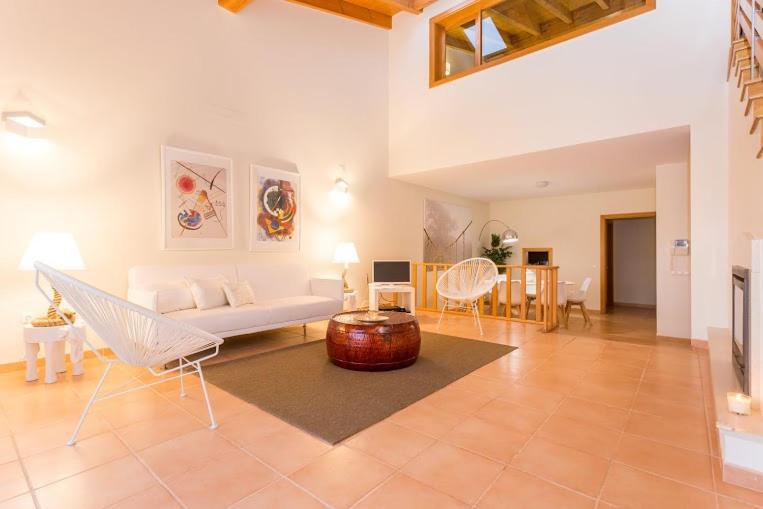 a living room with a white couch and a table at Villas T3 com Jardim Vila Sagres in Sagres