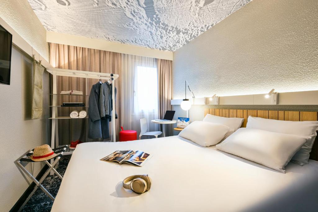a bedroom with a large white bed in a room at ibis Saint Rambert d'Albon in Saint-Rambert-dʼAlbon