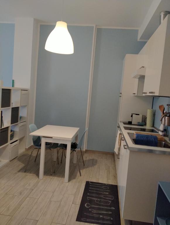 a kitchen with a table and a white table and a table and a tableearcher at Dimora Anna in Termoli