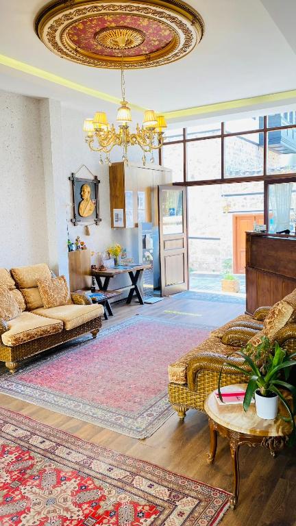 a living room with a couch and a chandelier at Kaleici Hotel in Antalya