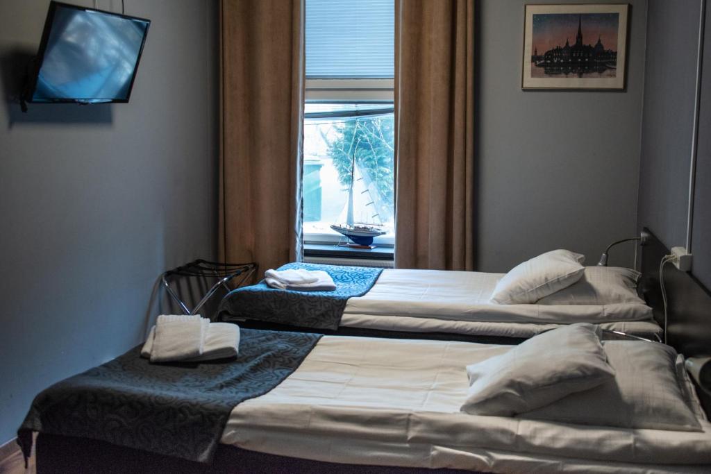 Postel nebo postele na pokoji v ubytování Reimersholme Hotel