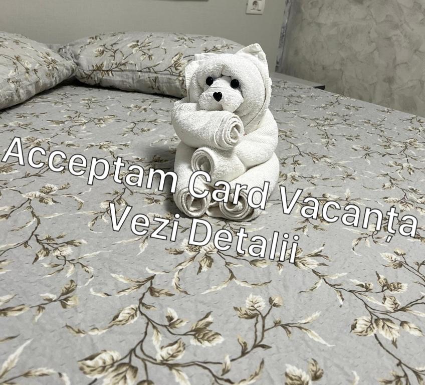 a teddy bear sitting on top of a bed at Casa Elena in Constanţa