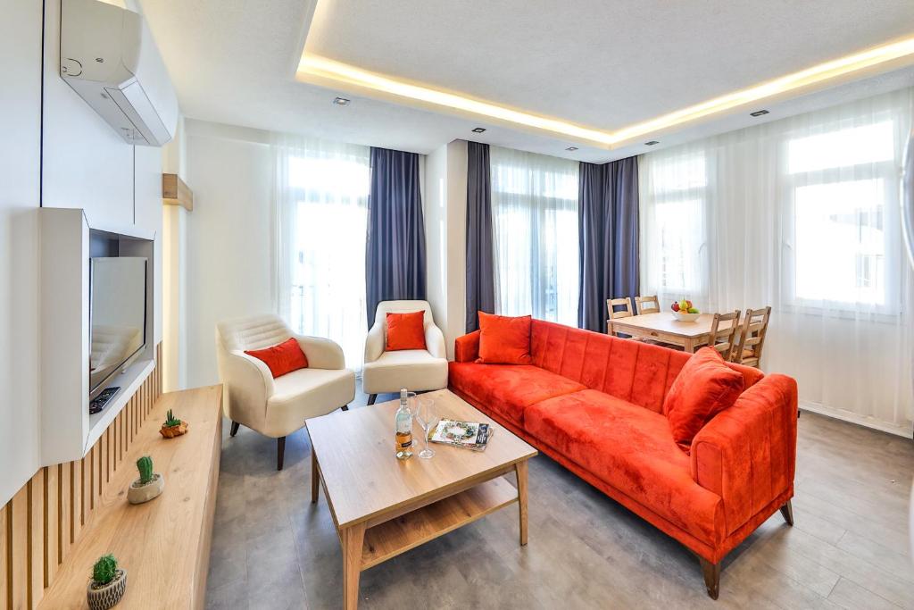 een woonkamer met een rode bank en een tafel bij Tuğçe Apart in Kas