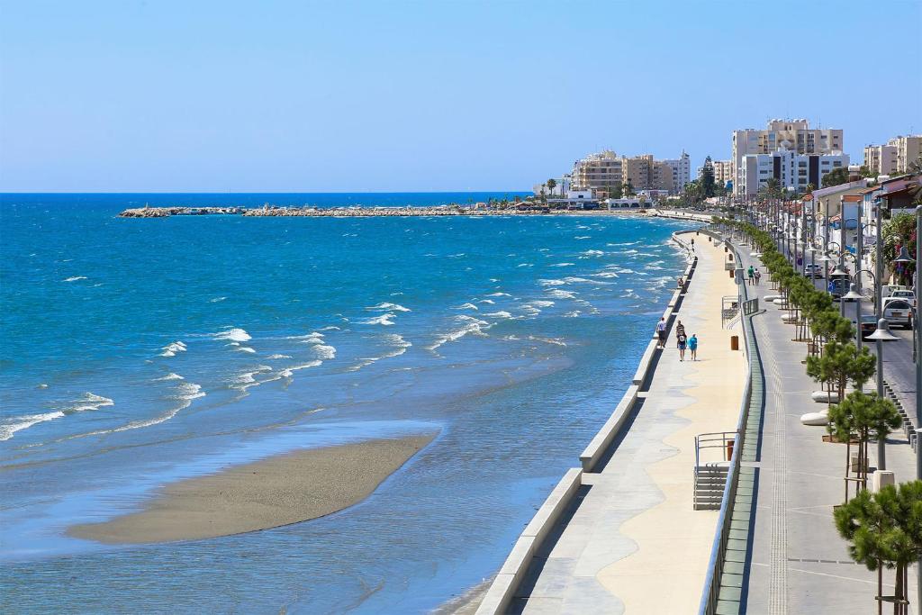 a view of a beach with the ocean and buildings at The Ciao Stelio Deluxe Boutique Hotel - Adults Only in Larnaka
