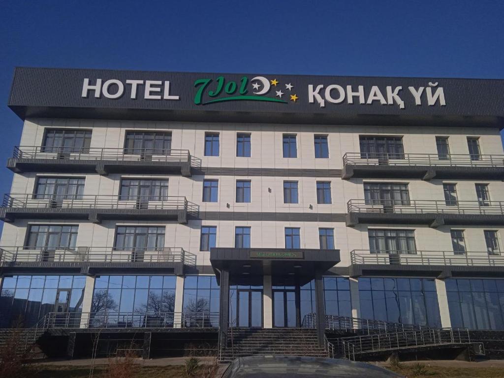 a hotel with a sign on the front of it at 7Jol Hotel in Khatynkopir