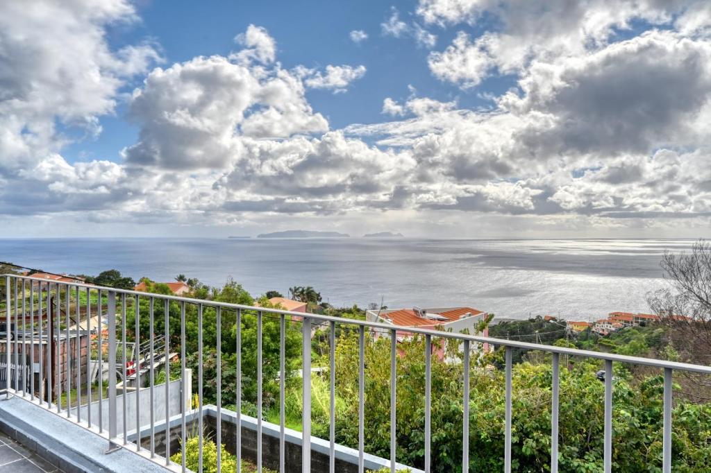 a view of the ocean from the balcony of a building at Villa 58, a Home in Madeira in Santa Cruz