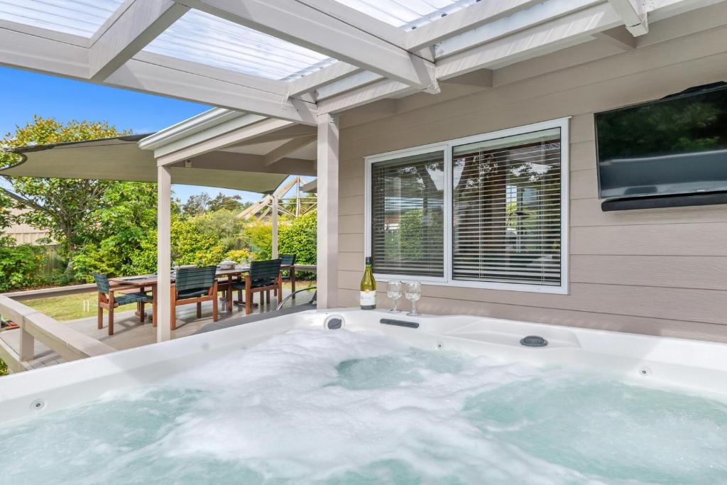 a jacuzzi tub in the backyard of a house at Piece of Paradise - Turangi Holiday Home in Turangi