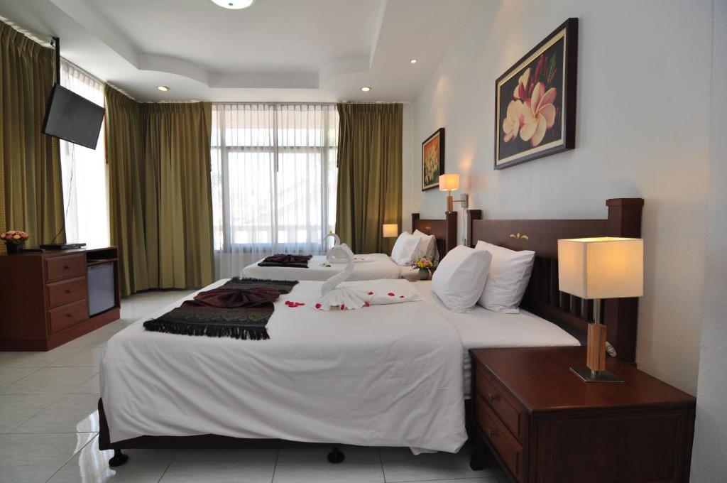 Postel nebo postele na pokoji v ubytování Phuket Leelavadee Hua Ting Resort