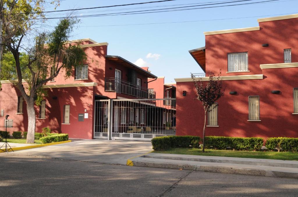 uma rua vazia em frente a um edifício vermelho em Complejo Mi Sueño em São Rafael