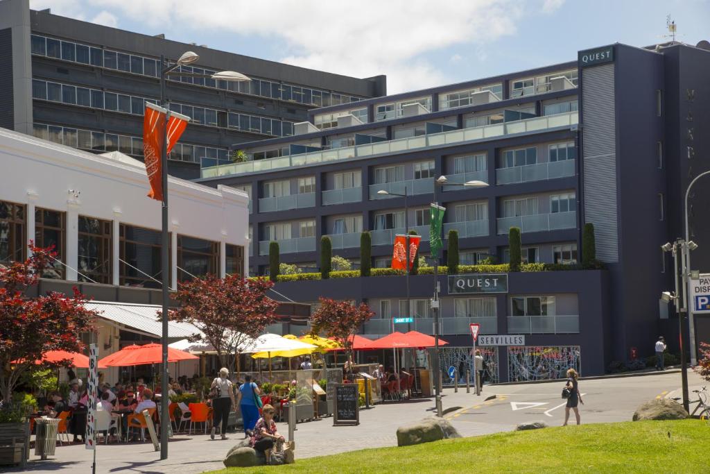 a building with people sitting in front of it at Quest Newmarket Serviced Apartments in Auckland