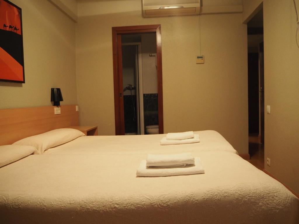 Postel nebo postele na pokoji v ubytování Hostal Acella